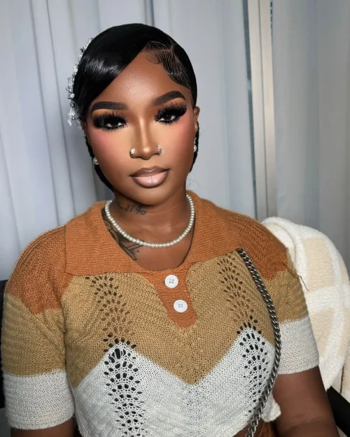 Black woman with make up. A brown lip liner and pale pink lipstick