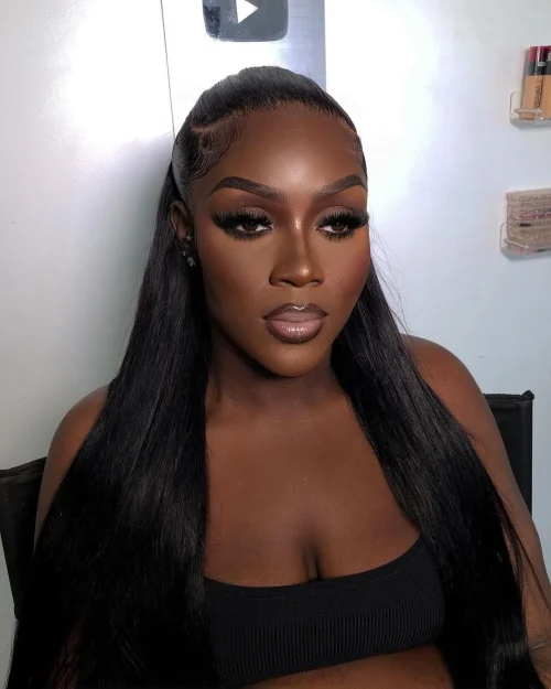 Black woman with make up. A brown lip liner and pale pink lipstick