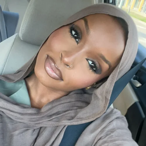 Black woman with make up. A brown lip liner and pale pink lipstick