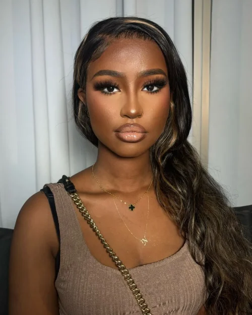 Black woman with make up. A brown lip liner and pale pink lipstick