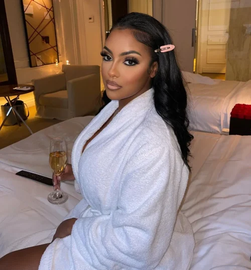 Black woman with make up. A brown lip liner and pale pink lipstick