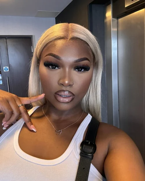 Black woman with make up. A brown lip liner and pale pink lipstick