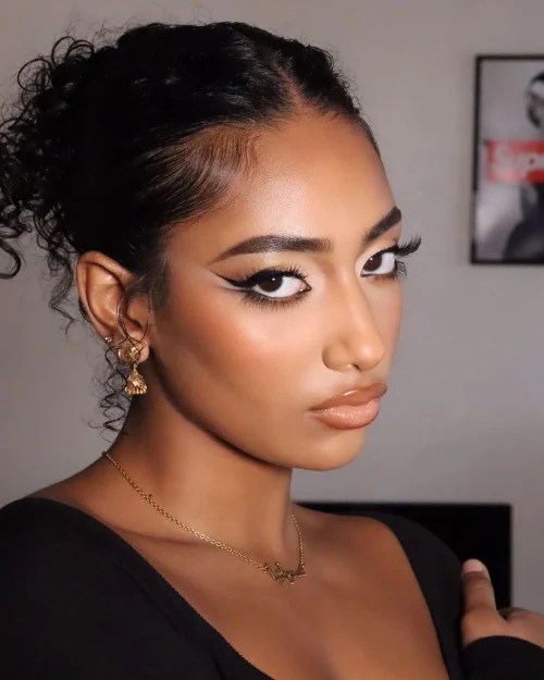 Black woman with make up. Black eyeliner to define the eyes with a double wing